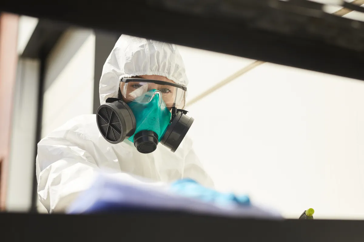 A technician applying antimicrobial treatment inside an HVAC system, illustrating professional duct mold treatment for a rental unit